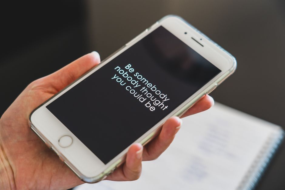 Close-up view of a smartphone displaying an inspirational quote, perfect for motivation and technology concepts.