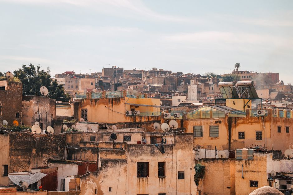 Explore the rustic charm of weathered rooftops and satellite-dotted buildings in an ancient city.