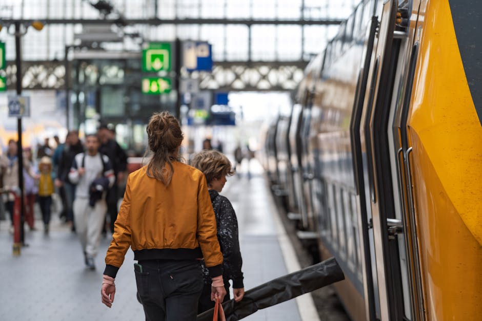 A woman and child boarding a train at a bustling station, capturing a moment of travel.