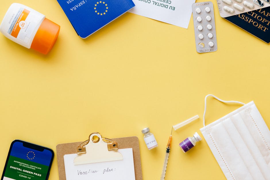 Flat lay of travel essentials including passport, mask, and vaccination pass.